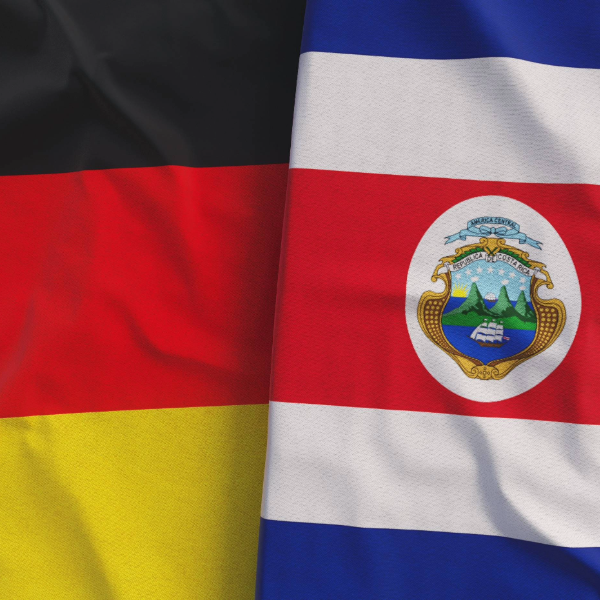The flags of Germany and Costa Rica lie flat next to each other.