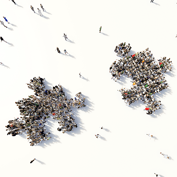 Many people forming two puzzle pieces seen from above
